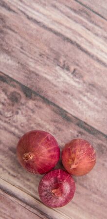 Shallots over wooden backgroundの写真素材