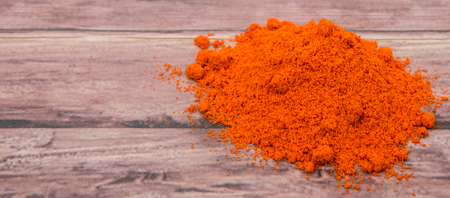 Cayenne pepper powder over wooden backgroundの写真素材