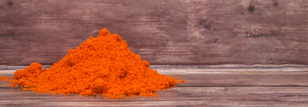 Cayenne pepper powder over wooden backgroundの写真素材