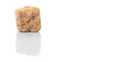 Brown sugarcane sugar cube over white backgroundの写真素材