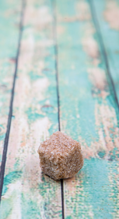 Brown sugarcane sugar cube over wooden backgroundの写真素材