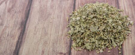 Dried marjoram herbs over wooden backgroundの写真素材