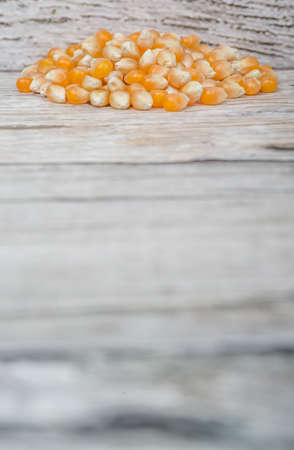Raw popcorn over wooden backgroundの写真素材