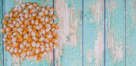 Raw popcorn over wooden backgroundの写真素材