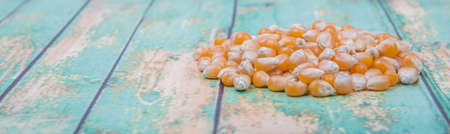 Raw popcorn over wooden backgroundの写真素材