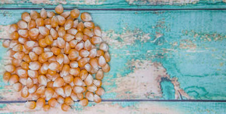 Raw popcorn over wooden backgroundの写真素材