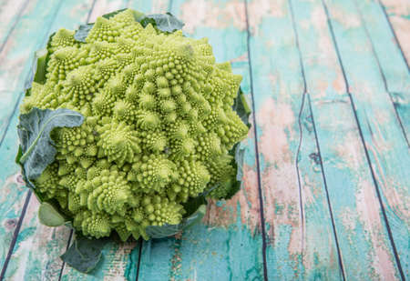 Romanesco broccoli or Roman cauliflower over wooden backgroundの写真素材
