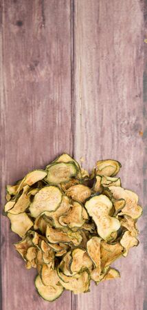 Dried zucchini or courgette over wooden backgroundの写真素材