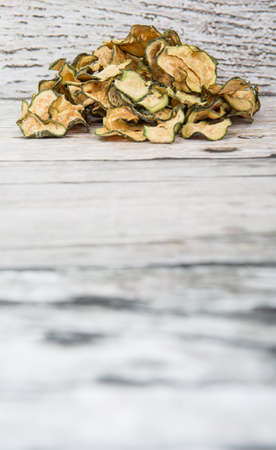 Dried zucchini or courgette over wooden backgroundの写真素材