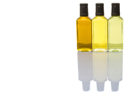 Avocado oil, olive oil and rapeseed oil over white backgroundの写真素材