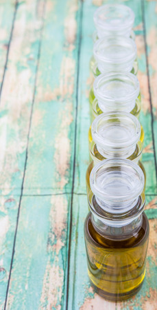 Avocado fruit oil, sesame seed oil, olive oil, grape seed oil and corn oil in vial glass bottle over...