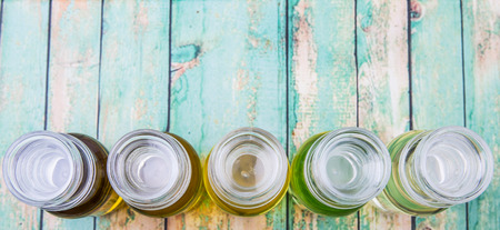 Avocado fruit oil, sesame seed oil, olive oil, grape seed oil and corn oil in vial glass bottle over...