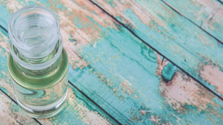 Corn vegetable cooking oil in vial glass over wooden backgroundの写真素材