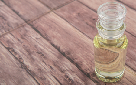 Corn vegetable cooking oil in vial glass over wooden backgroundの写真素材