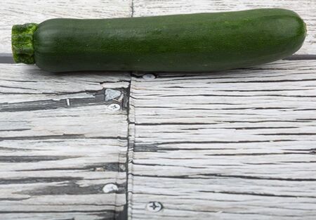Green zucchini over wooden backgroundの写真素材