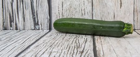 Green zucchini over wooden backgroundの写真素材