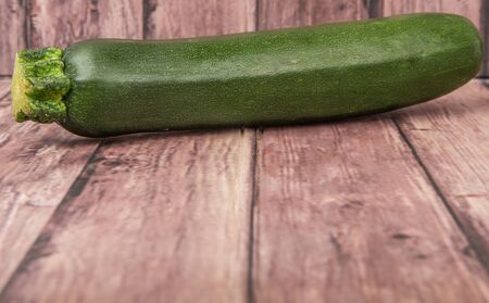 Green zucchini over wooden backgroundの写真素材