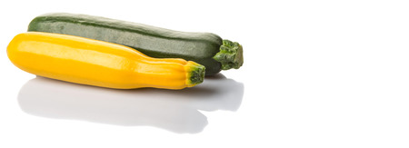 Yellow and green zucchini vegetable over white backgroundの写真素材