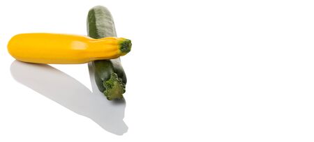 Yellow and green zucchini vegetable over white backgroundの写真素材