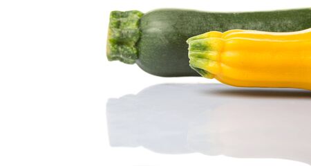 Yellow and green zucchini vegetable over white backgroundの写真素材