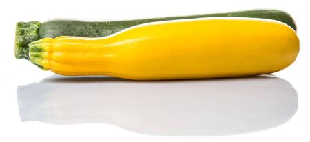 Yellow and green zucchini vegetable over white backgroundの写真素材