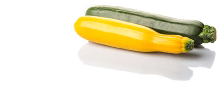 Yellow and green zucchini vegetable over white backgroundの写真素材