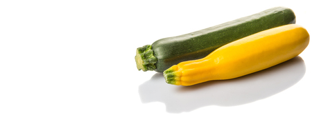 Yellow and green zucchini vegetable over white backgroundの写真素材