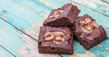 Chocolate walnut brownies over wooden backgroundの写真素材