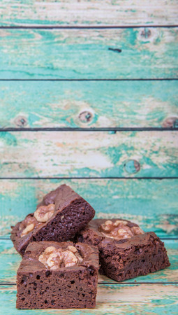 Chocolate walnut brownies over wooden backgroundの写真素材