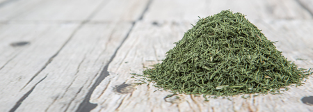 Dried dill herbs over rustic wooden backgroundの写真素材