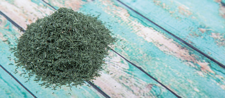 Dried dill herbs over rustic wooden backgroundの写真素材
