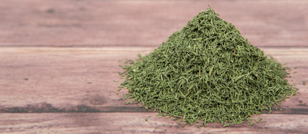 Dried dill herbs over rustic wooden backgroundの写真素材