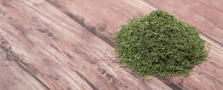 Dried dill herbs over rustic wooden backgroundの写真素材