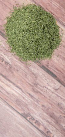Dried dill herbs over rustic wooden backgroundの写真素材