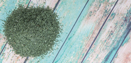 Dried dill herbs over rustic wooden backgroundの写真素材