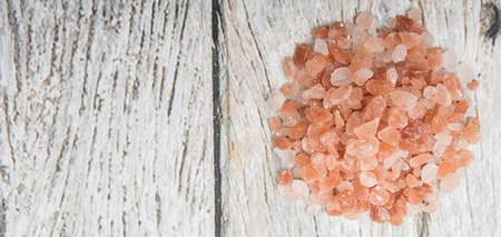 Himalaya or Himalayan rock salt over wooden backgroundの写真素材