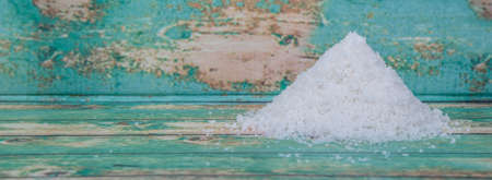 Dried coconut powder over wooden backgroundの写真素材