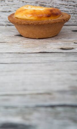 Homemade Japanese cheese tart over wooden backgroundの写真素材