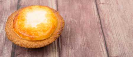 Homemade Japanese cheese tart over wooden background