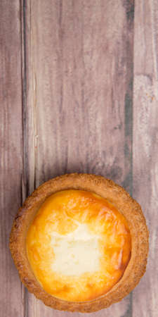 Homemade Japanese cheese tart over wooden background