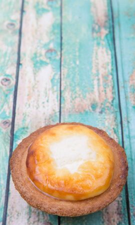 Homemade Japanese cheese tart over wooden backgroundの写真素材