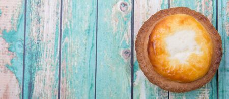 Homemade Japanese cheese tart over wooden background