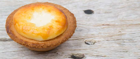Homemade Japanese cheese tart over wooden background