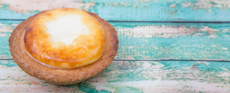Homemade Japanese cheese tart over wooden background