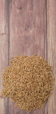 Dried anise seed or aniseed over wooden backgroundの写真素材