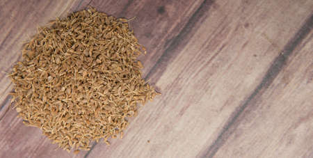Dried anise seed or aniseed over wooden backgroundの写真素材