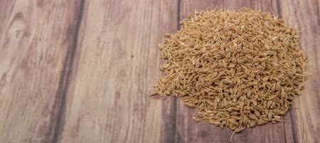 Dried anise seed or aniseed over wooden backgroundの写真素材