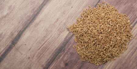 Dried anise seed or aniseed over wooden backgroundの写真素材