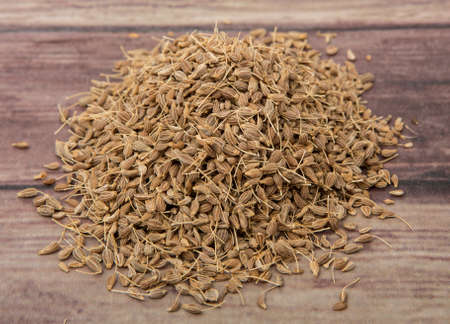 Dried anise seed or aniseed over wooden backgroundの写真素材