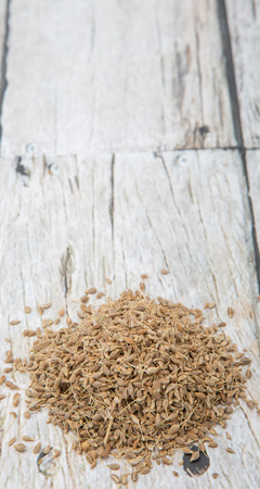 Dried anise seed or aniseed over wooden backgroundの写真素材